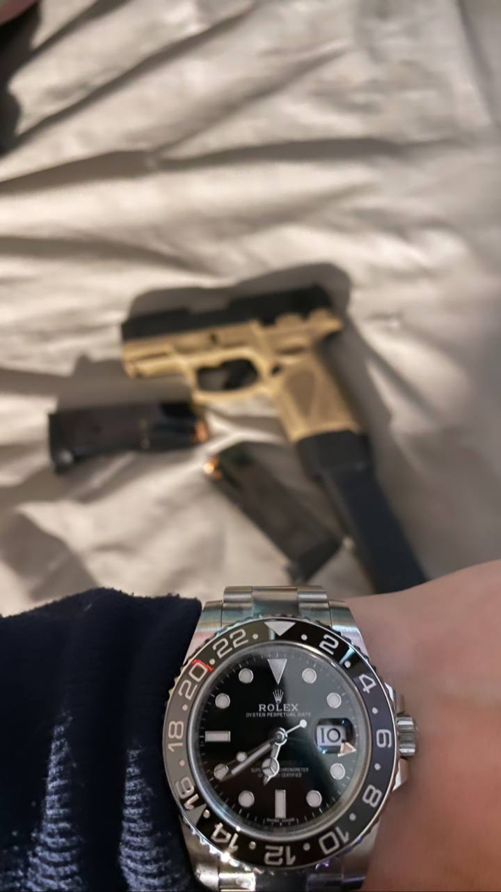 A photo of a watch and weapon uploaded to a group chat where data access is advertised.