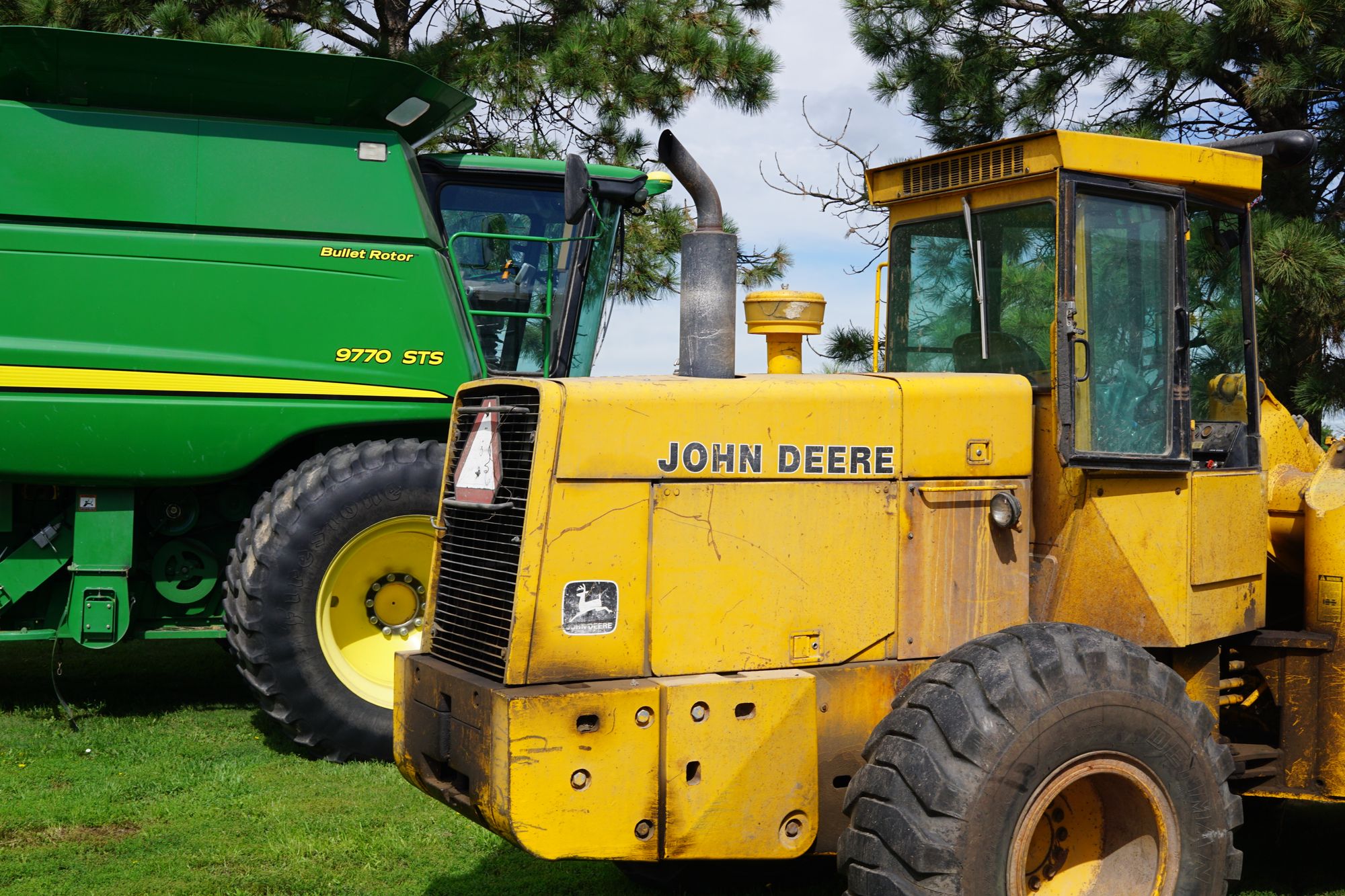 A John Deere tractor and combine.