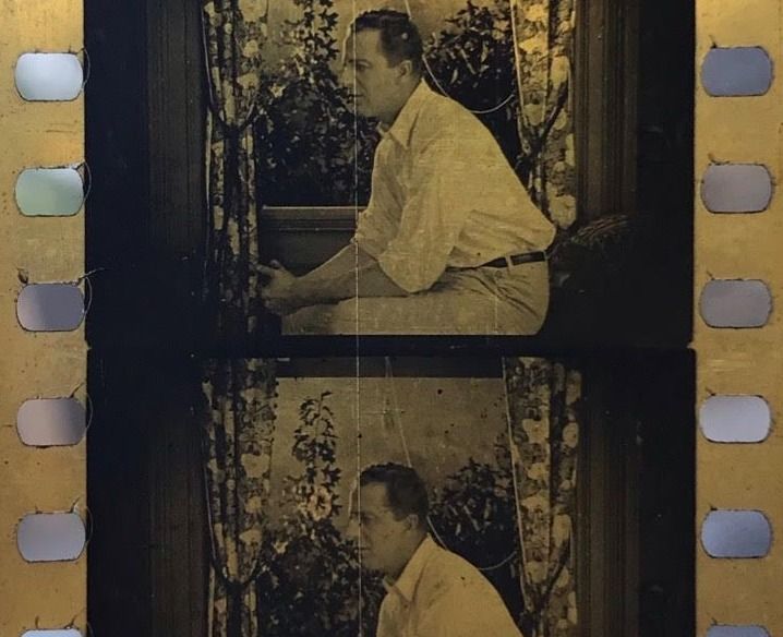 Two frames of a film, featuring a man sitting in front of a window, facing left of camera